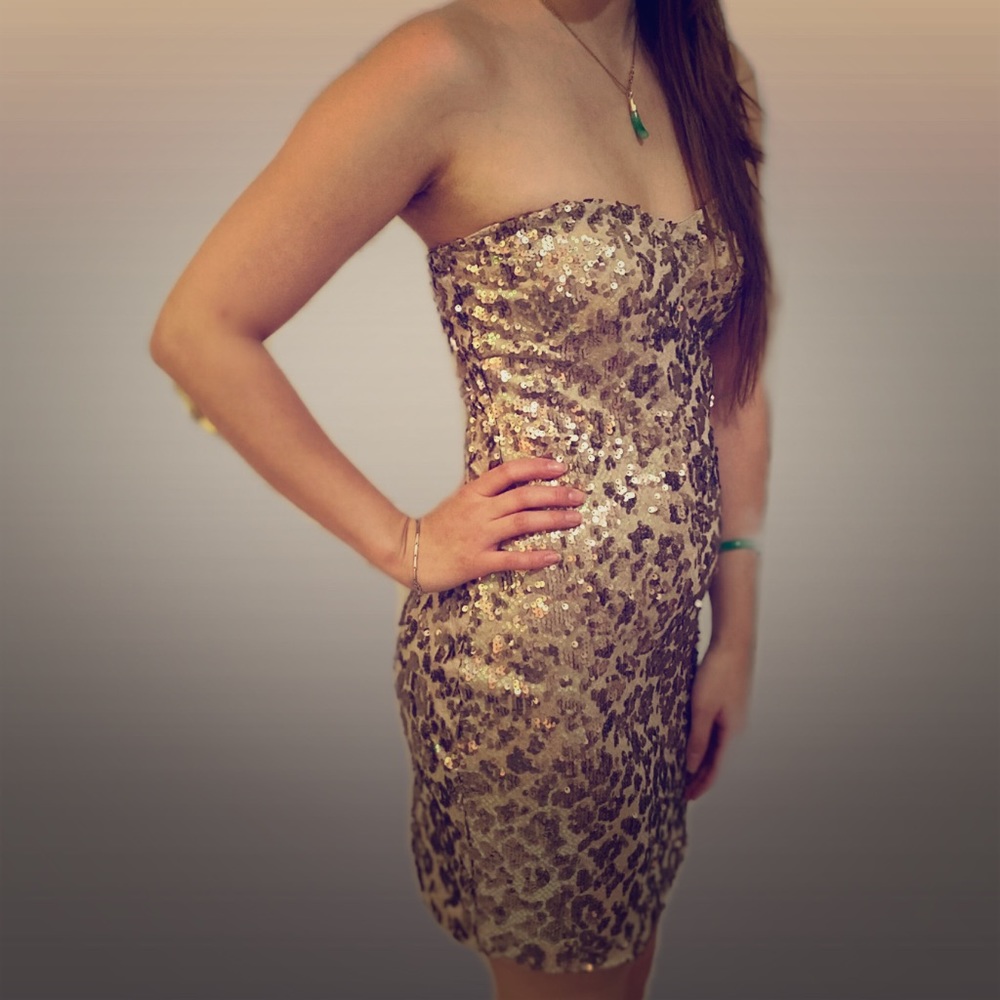 An strapless gold sequin party dress